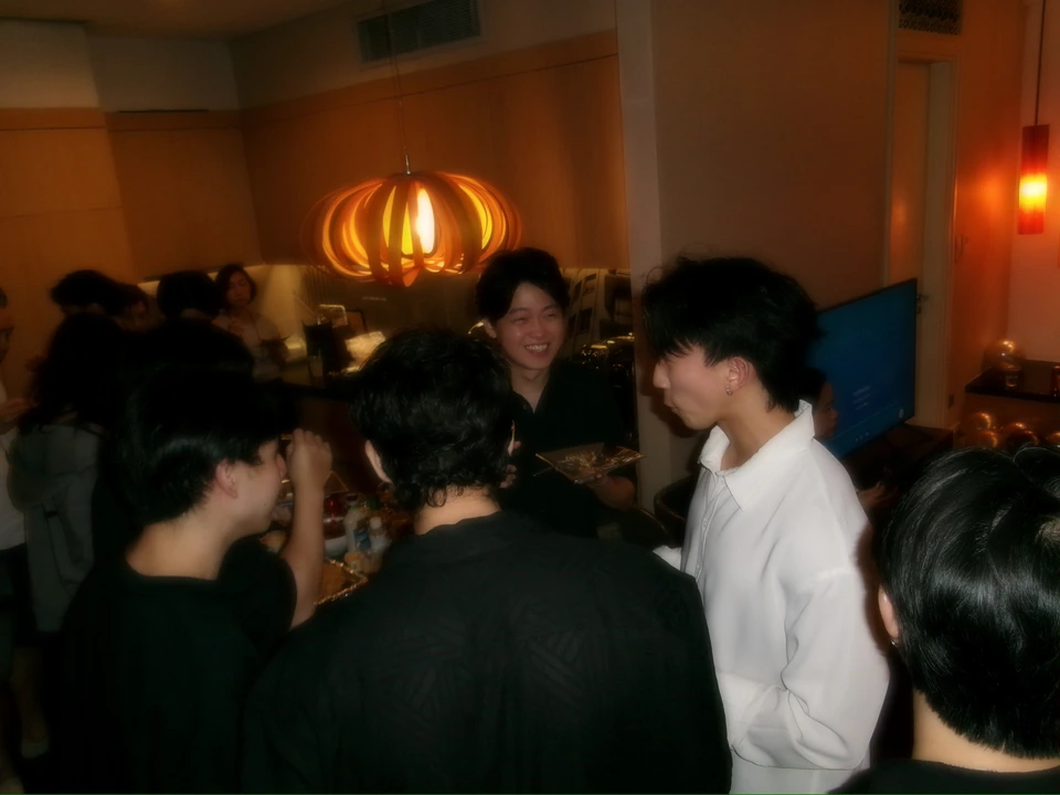 A candid birthday gathering with friends in a warmly lit room.